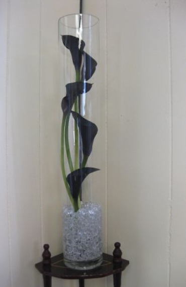 Black mini calla lilies staggered in glass cylinder wedding cent