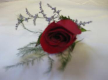 Classic Red Boutonierre finished with limonium for the Best Man